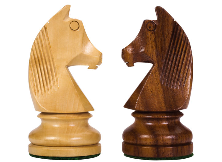 Close-up of chess knights face to face