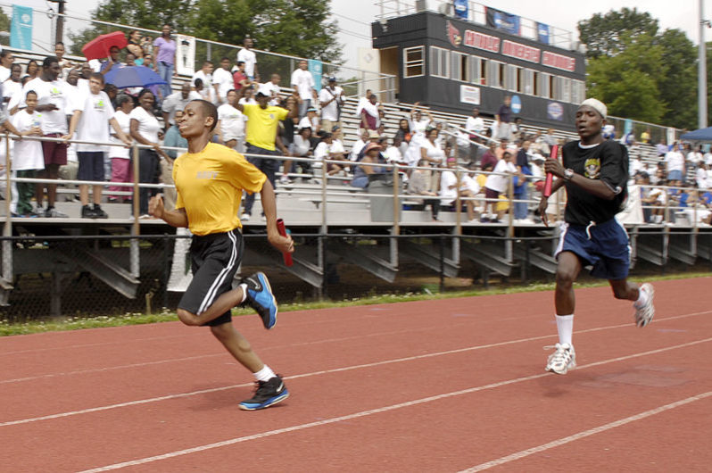Flickr_-_Official_U.S._Navy_Imagery_-_Runners_at_the_2012_Washington_D.C._Special_Olympics_represent_the_U.S._Navy_and_Army_during_a_4x100_meter_relay_race_at_the_2012_Washington_D.C._Special_Olympics.