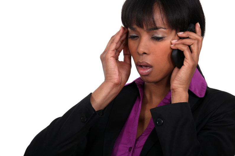 Office worker receiving bad news over the telephone