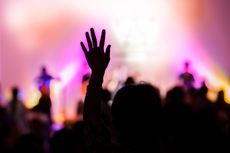 christian music concert with raised hand